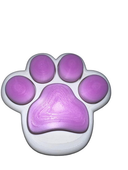 Purple paw-shaped object on a gray fabric background