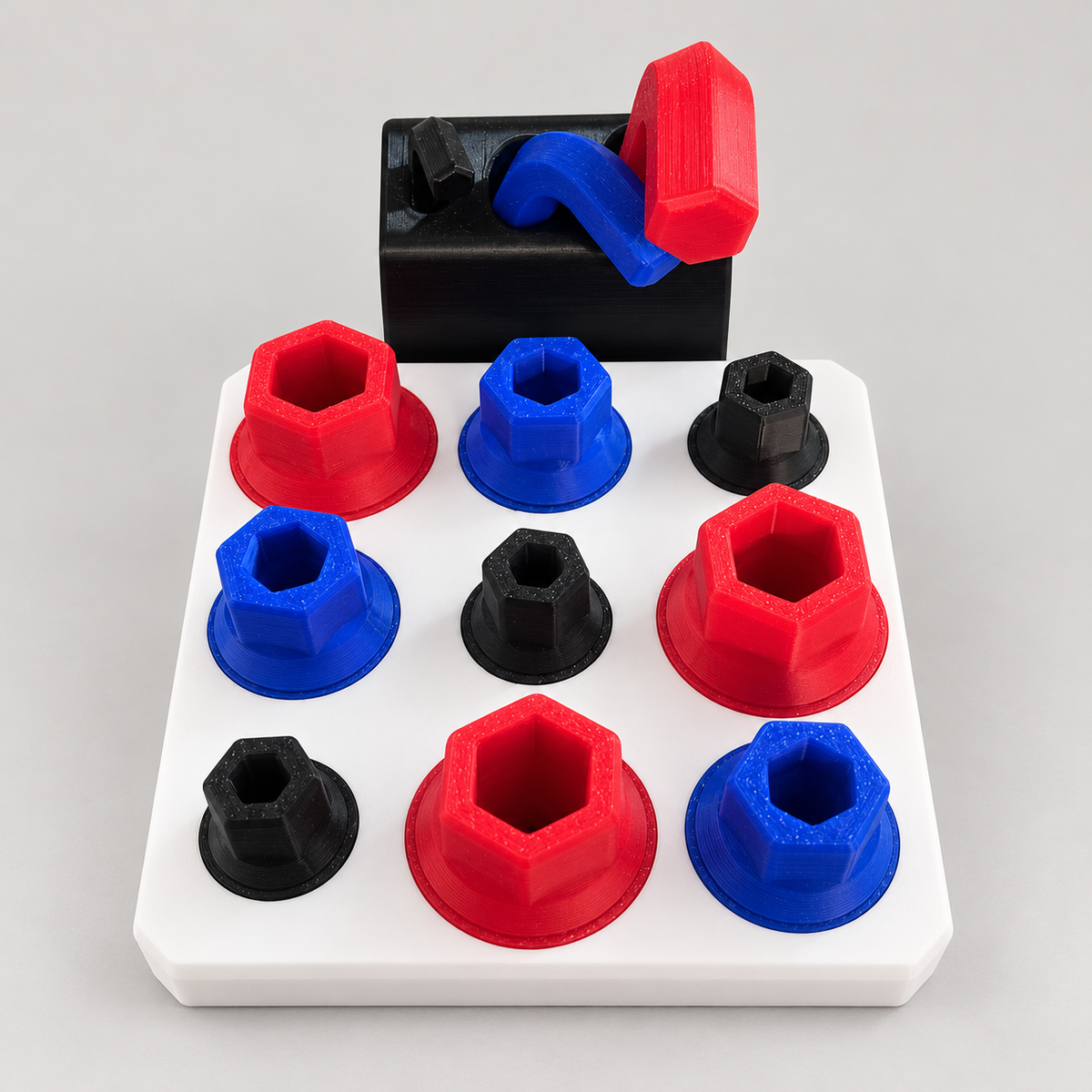 Allen Key Activity Board with red, blue and black screw pieces and matching tools on a white base