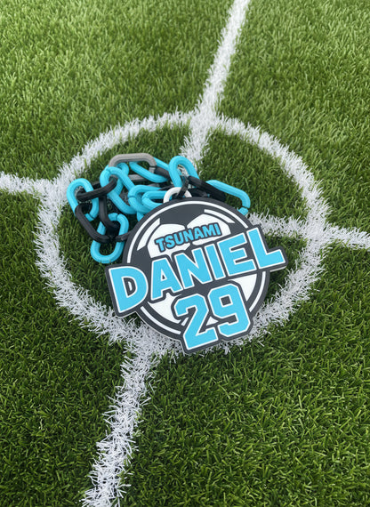Circular badge with 'Tsunami Daniel' branding on a cardboard background